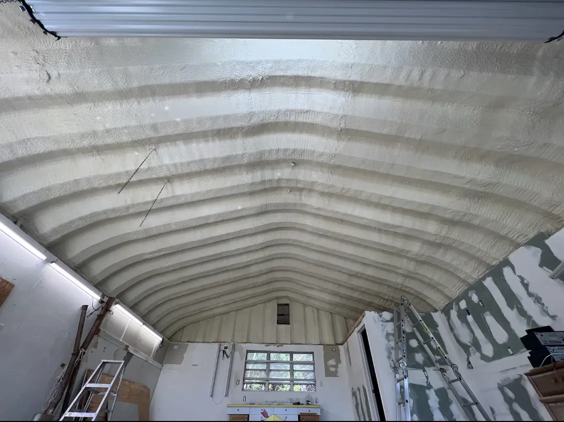 Spray polyurethane foam applied to the underside of a metal roof deck in Houston